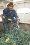 Man with fishing nets inside boat