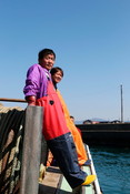 Japanese fishermen at port smiling looking towards camera