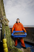 Jan Marcus holding tray orange oil skins Dutch