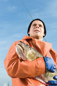 German fisherman holding fish  CURRENTLY SUSPENDED