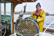 Crab fisher with pot-creel