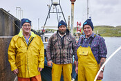 Crab fishers in front of vessel