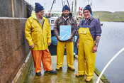 Crab fishers in front of vessel