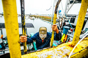 Jack Vantress climbing onto fishing boat - AAFA fishery