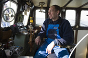German fisherman sitting at wheel of boat Mike Hilger  CURRENTLY SUSPENDED
