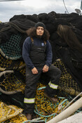 Squid fisher on fishing nets, California Market Squid