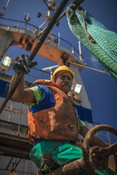 Fisherman looking towards camera and sitting south african Hake fishery